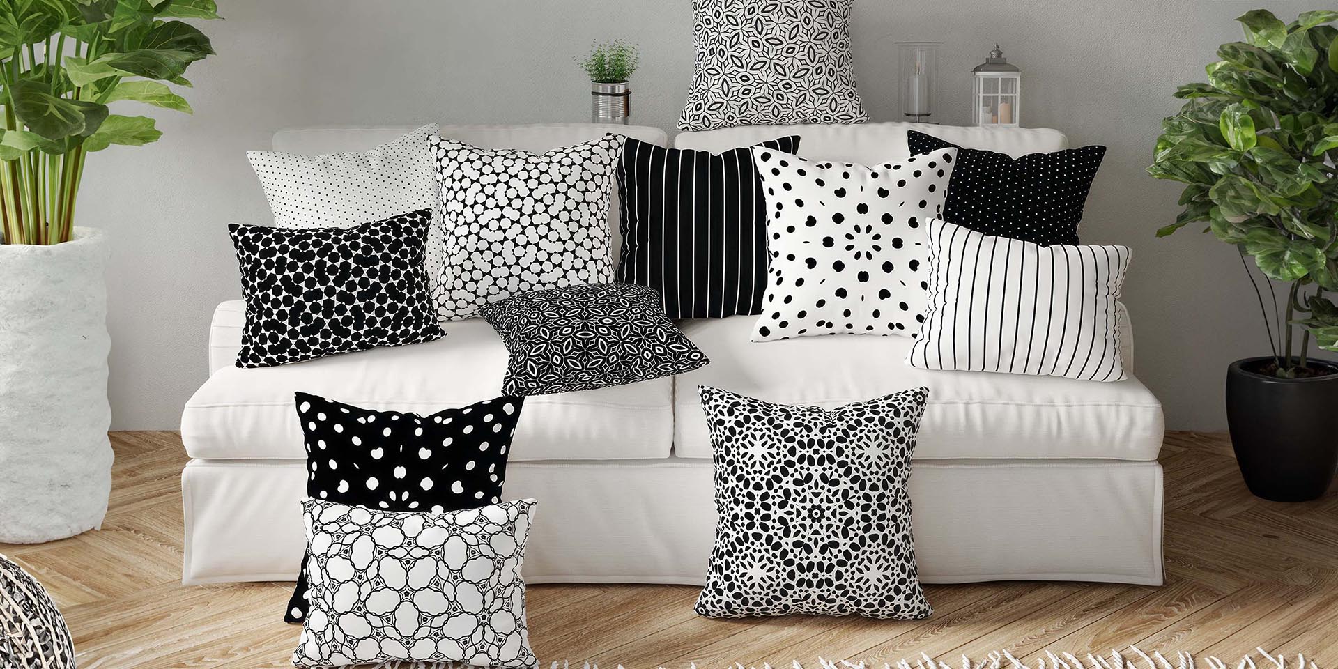White sofa with black and white patterned cushions in a living room setting.