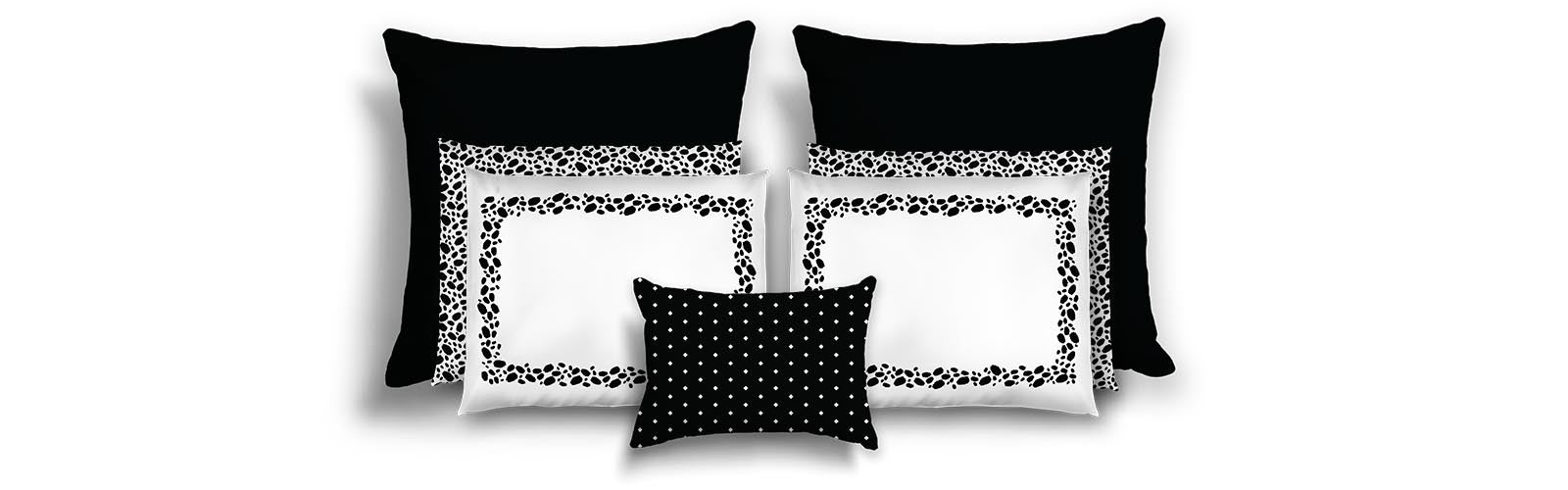 Set of black and white patterned pillows on a white background