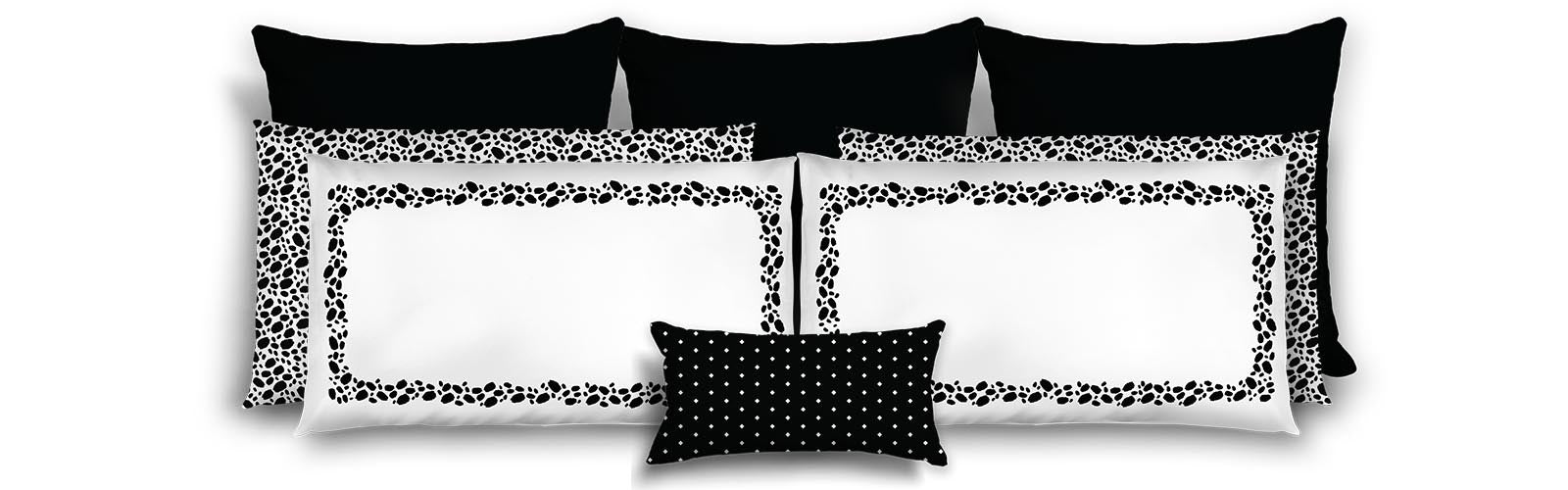 Set of black and white decorative pillows with geometric patterns on a white background