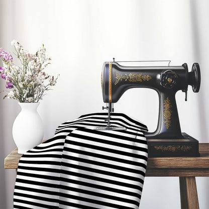 White Cotton Sateen Fabric with Black Bars, FACS-1010-051, on an antique sewing machine sitting on a desk with vase of beautiful flowers.