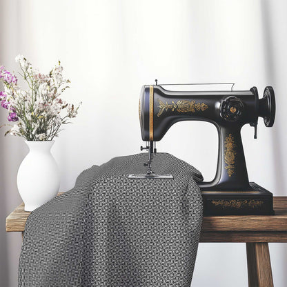 Off-White Cotton Sateen Fabric with Black Double Weave Motif Print, FASC-1010-144, on an antique sewing machine sitting on a desk with vase of beautiful flowers.