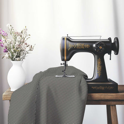 Pale Cream Cotton Sateen Fabric with Black Double Weave Motif Print, FASC-1013-144, on an antique sewing machine sitting on a desk with vase of beautiful flowers.