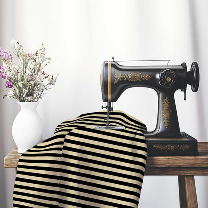 Cotton Sateen Fabric with Black Bars on Tan, FACS-1014-051, on an antique sewing machine sitting on a desk with vase of beautiful flowers.