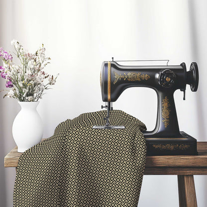 Tan Cotton Sateen Fabric with Black Repeating Square Motif Print, FASC-1014-122, on an antique sewing machine sitting on a desk with vase of beautiful flowers.