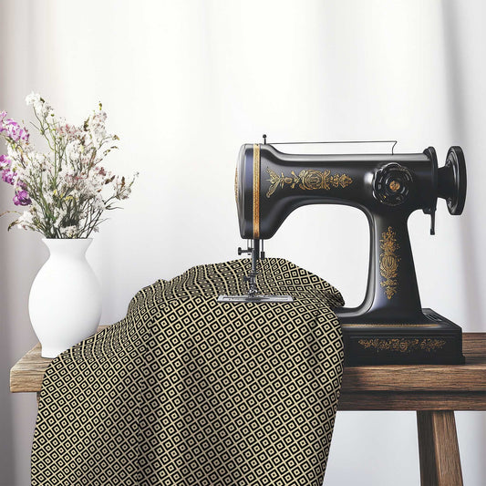 Tan Cotton Sateen Fabric with Black Repeating Square Motif Print, FASC-1014-122, on an antique sewing machine sitting on a desk with vase of beautiful flowers.