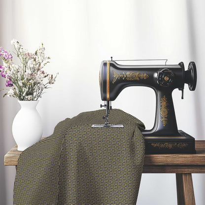 Tan Cotton Sateen Fabric with Black Single Weave Motif Print, FASC-1014-142, on an antique sewing machine sitting on a desk with vase of beautiful flowers.