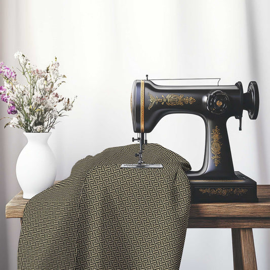 Tan Cotton Sateen Fabric with Black Single Weave Motif Print, FASC-1014-142, on an antique sewing machine sitting on a desk with vase of beautiful flowers.