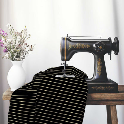 Cotton Sateen Fabric with Fine Tan Stripes on Black, FACS-1014-152, on an antique sewing machine sitting on a desk with vase of beautiful flowers.
