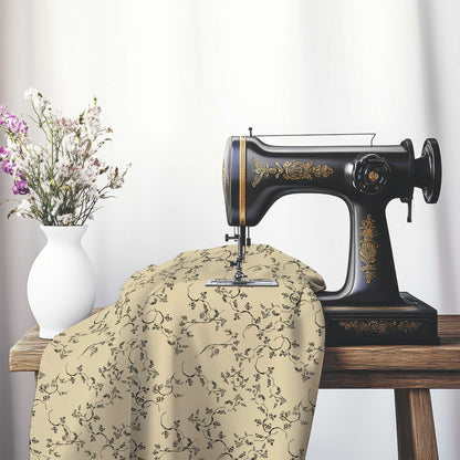 Tan Cotton Sateen Fabric with Black Hand-painted Vine Print, FASC-1014-181, on an antique sewing machine sitting on a desk with vase of beautiful flowers.
