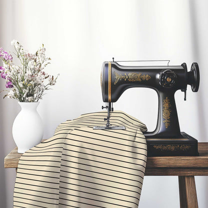 Cotton Sateen Fabric with Fine Black Stripes on Beige, FACS-1015-151, on an antique sewing machine sitting on a desk with vase of beautiful flowers.