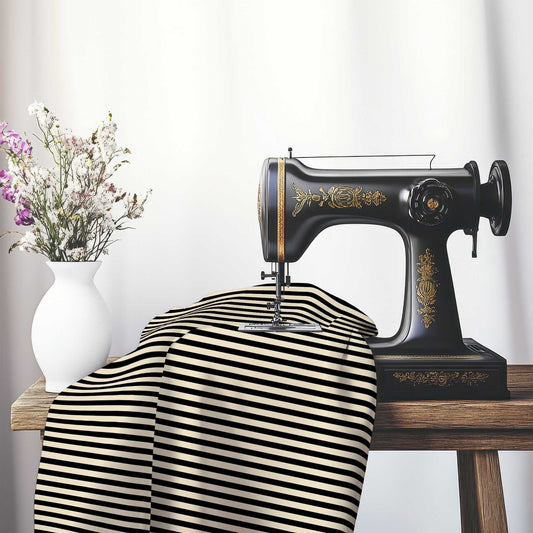 Cotton Sateen Fabric with Thin Black Bars on Beige, FACS-1015-241, on an antique sewing machine sitting on a desk with vase of beautiful flowers.