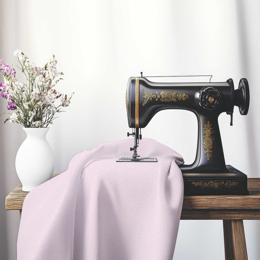 Off-White Cotton Sateen Fabric with Pink Double Weave Motif Print, FASC-1081-144, on an antique sewing machine sitting on a desk with vase of beautiful flowers.