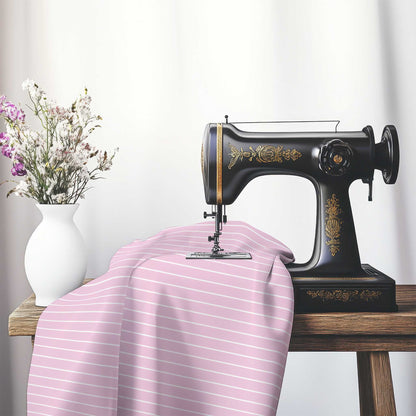 Cotton Sateen Fabric with Fine White Stripes on Pink, FACS-1081-152, on an antique sewing machine sitting on a desk with vase of beautiful flowers.