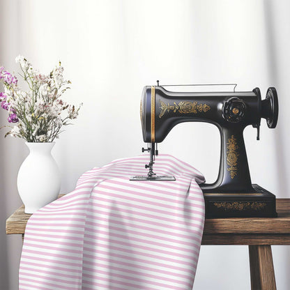 White Cotton Sateen Fabric with Thin Pink Bars, FACS-1081-241, on an antique sewing machine sitting on a desk with vase of beautiful flowers.