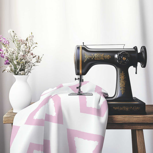 Off-White Cotton Sateen Fabric with Bold Pink Graphic , FASC-1081-391, on an antique sewing machine sitting on a desk with vase of beautiful flowers.
