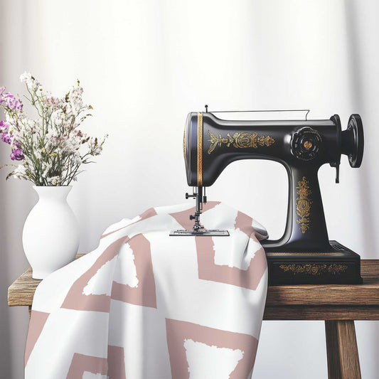 Off-White Cotton Sateen Fabric with Bold Salmon Graphic , FASC-1139-391, on an antique sewing machine sitting on a desk with vase of beautiful flowers.