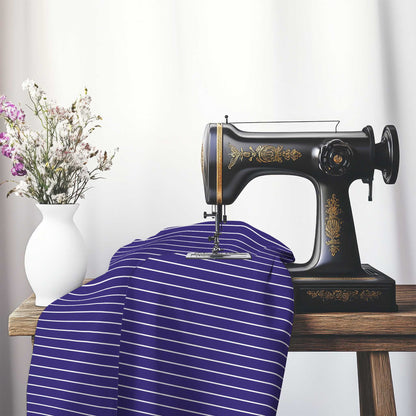 Cotton Sateen Fabric with Fine White Stripes on Purple, FACS-1143-152, on an antique sewing machine sitting on a desk with vase of beautiful flowers.