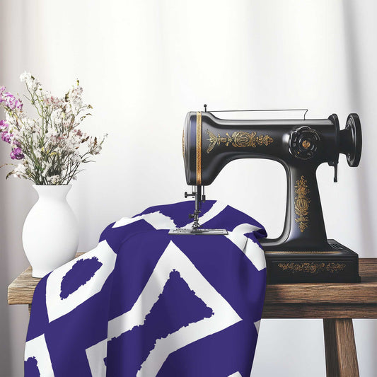 Purple Cotton Sateen Fabric with Bold Off-White Graphic , FASC-1143-392, on an antique sewing machine sitting on a desk with vase of beautiful flowers.