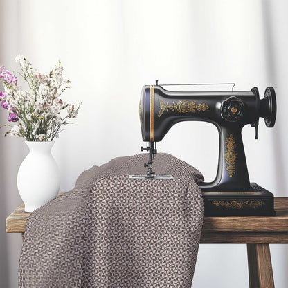 Off-White Cotton Sateen Fabric with Brown Double Weave Motif Print, FASC-1161-144, on an antique sewing machine sitting on a desk with vase of beautiful flowers.