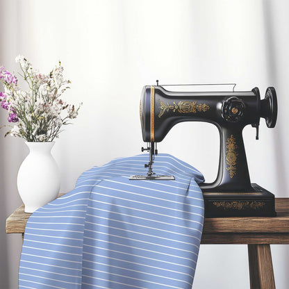 Cotton Sateen Fabric with Fine White Stripes on Blue, FACS-1231-152, on an antique sewing machine sitting on a desk with vase of beautiful flowers.