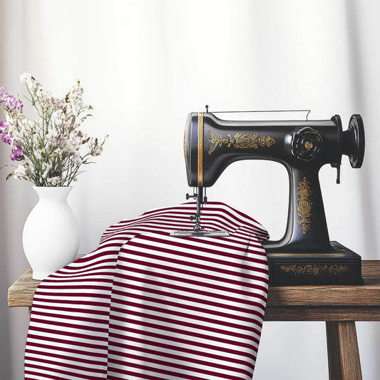 White Cotton Sateen Fabric with Thin Burgundy Red Bars, FACS-1281-241, on an antique sewing machine sitting on a desk with vase of beautiful flowers.
