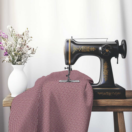 Pale Cream Cotton Sateen Fabric with Burgundy Red Single Weave Motif Print, FASC-1283-142, on an antique sewing machine sitting on a desk with vase of beautiful flowers.
