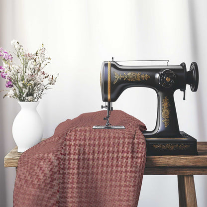 Tan Cotton Sateen Fabric with Burgundy Red Double Weave Motif Print, FASC-1284-144, on an antique sewing machine sitting on a desk with vase of beautiful flowers.