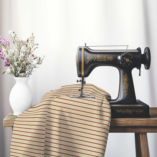 Cotton Sateen Fabric with Fine Burgundy Red Stripes on Tan, FACS-1284-151, on an antique sewing machine sitting on a desk with vase of beautiful flowers.