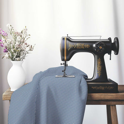 Off-White Cotton Sateen Fabric with Royal Blue Double Weave Motif Print, FASC-1291-144, on an antique sewing machine sitting on a desk with vase of beautiful flowers.