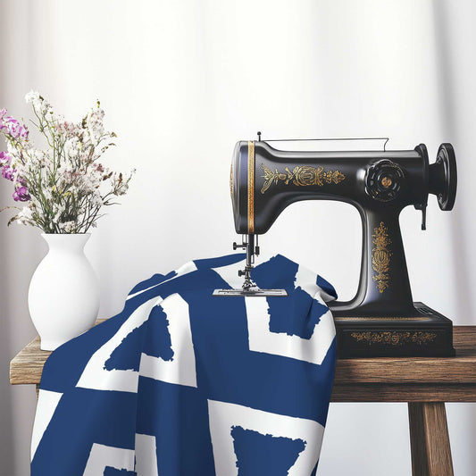 Royal Blue Cotton Sateen Fabric with Bold Off-White Graphic , FASC-1291-392, on an antique sewing machine sitting on a desk with vase of beautiful flowers.