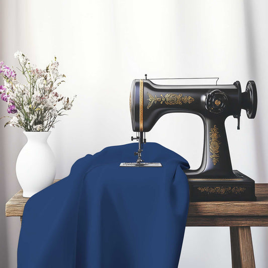Royal Blue Cotton Sateen Fabric, FACS-1291-999, on an antique sewing machine sitting on a desk with vase of beautiful flowers.