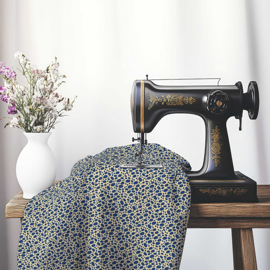 Tan Cotton Sateen Fabric with Royal Blue Hand-painted Dab Motif Print, FASC-1294-092, on an antique sewing machine sitting on a desk with vase of beautiful flowers.