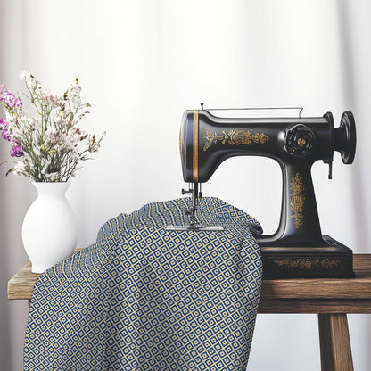 Tan Cotton Sateen Fabric with Royal Blue Repeating Square Motif Print, FASC-1294-122, on an antique sewing machine sitting on a desk with vase of beautiful flowers.