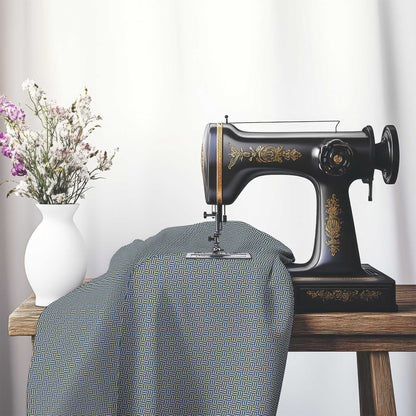 Tan Cotton Sateen Fabric with Royal Blue Double Weave Motif Print, FASC-1294-144, on an antique sewing machine sitting on a desk with vase of beautiful flowers.