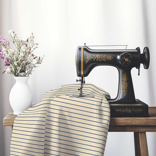 Cotton Sateen Fabric with Fine Royal Blue Stripes on Beige, FACS-1295-151, on an antique sewing machine sitting on a desk with vase of beautiful flowers.