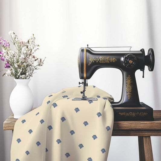 Beige Cotton Sateen Fabric with Royal Blue Hand-painted Swizzle Motif Print, FASC-1295-171, on an antique sewing machine sitting on a desk with vase of beautiful flowers.