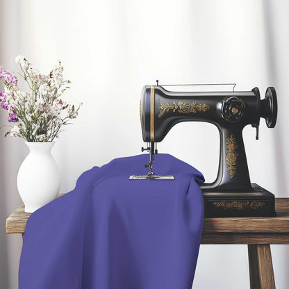 Purple Cotton Sateen Handpainted Purple Watercolor Print, FACS-1300-999, on an antique sewing machine sitting on a desk with vase of beautiful flowers.