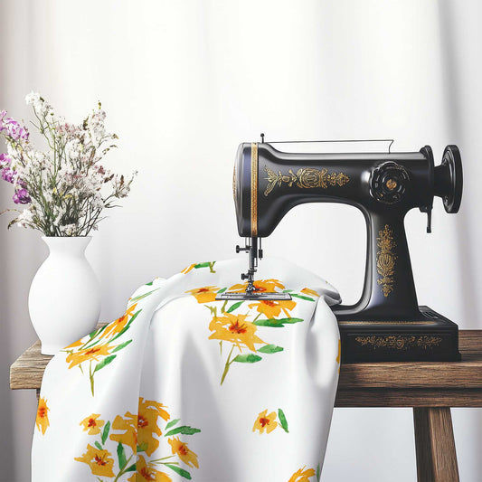 Printed Fabric with Handpainted Yellow-Orange Watercolor Floral, FACS-1314, on an antique sewing machine sitting on a desk with vase of beautiful flowers.