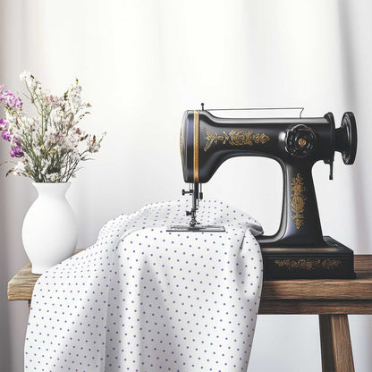 White Cotton Sateen Fabric with Fine Purple Diamonds, FACS-1320-111, on an antique sewing machine sitting on a desk with vase of beautiful flowers.