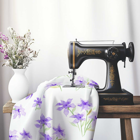 Printed Fabric with Handpainted Purple Watercolor Floral, FACS-1324, on an antique sewing machine sitting on a desk with vase of beautiful flowers.