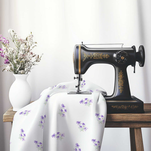 Printed Fabric with Handpainted Purple Watercolor Floral Pattern, FACS-1325, on an antique sewing machine sitting on a desk with vase of beautiful flowers.