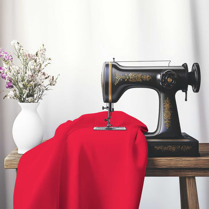 Red Cotton Sateen Handpainted Purple Watercolor Print, FACS-1330-999, on an antique sewing machine sitting on a desk with vase of beautiful flowers.