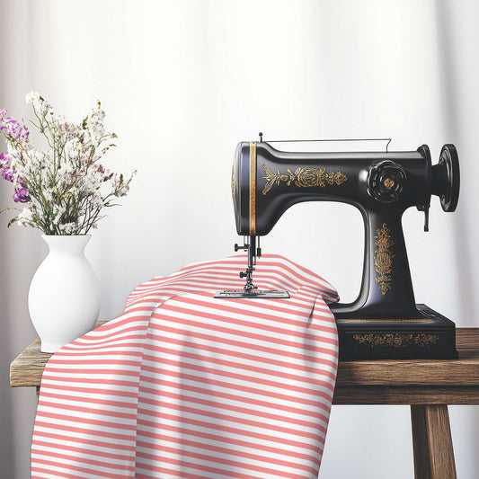 White Cotton Sateen Fabric with Thin Pink Bars, FACS-1340-241, on an antique sewing machine sitting on a desk with vase of beautiful flowers.
