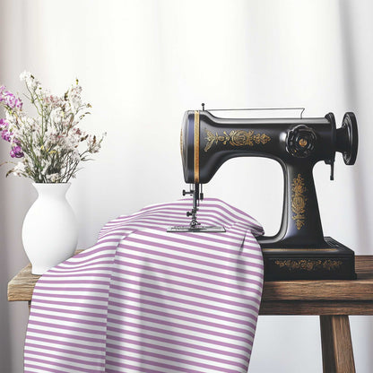White Cotton Sateen Fabric with Thin Mauve Bars, FACS-1360-241, on an antique sewing machine sitting on a desk with vase of beautiful flowers.