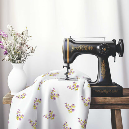 Printed Fabric with Handpainted Mauve Watercolor Floral Pattern, FACS-1365, on an antique sewing machine sitting on a desk with vase of beautiful flowers.