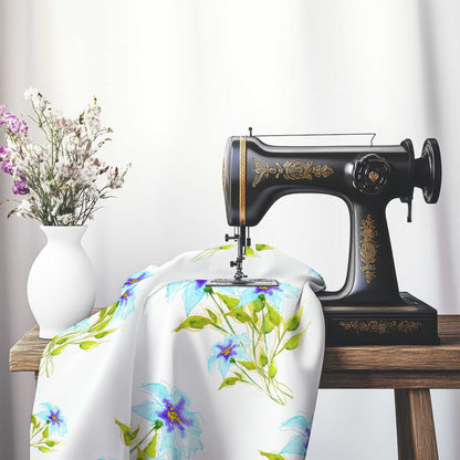 Printed Fabric with Handpainted Blue Watercolor Floral, FACS-1374, on an antique sewing machine sitting on a desk with vase of beautiful flowers.