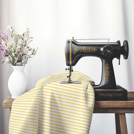 White Cotton Sateen Fabric with Thin Yellow Bars, FACS-1381-241, on an antique sewing machine sitting on a desk with vase of beautiful flowers.
