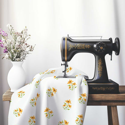 Printed Fabric with Handpainted Yellow-Orange Watercolor Floral Pattern, FACS-1395, on an antique sewing machine sitting on a desk with vase of beautiful flowers.