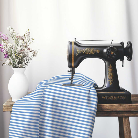 White Cotton Sateen Fabric with Thin Blue Bars, FACS-1400-241, on an antique sewing machine sitting on a desk with vase of beautiful flowers.