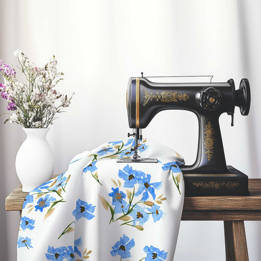 Printed Fabric with Handpainted Blue Watercolor Floral, FACS-1404, on an antique sewing machine sitting on a desk with vase of beautiful flowers.